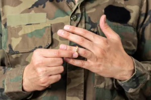 A military service member removing his wedding ring.