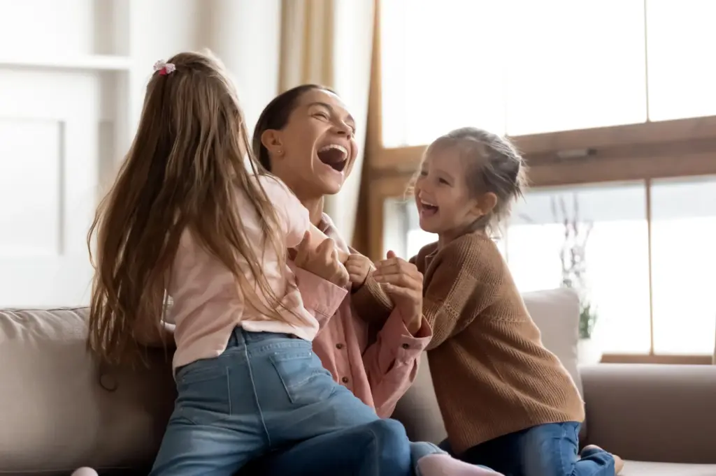 Mom and children laughing together.