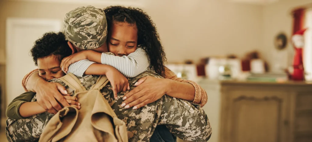 A military family hugging.