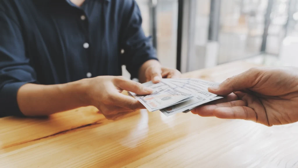 A man handing over money,