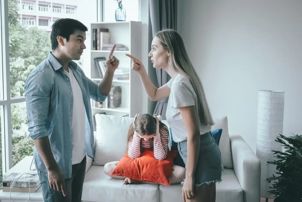 A man and wife fighting in front of their children.