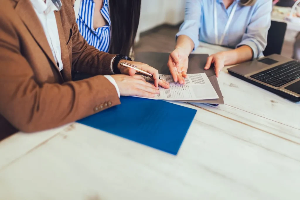 An attorney going over paperwork with her clients.