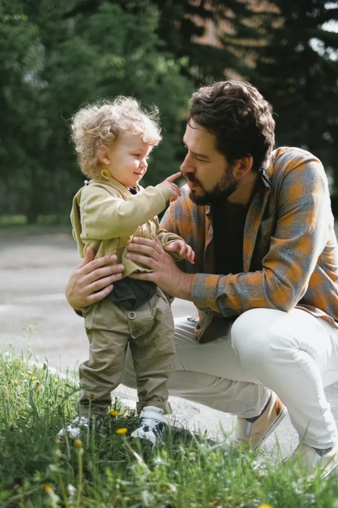 A father playing outdoors with his child.