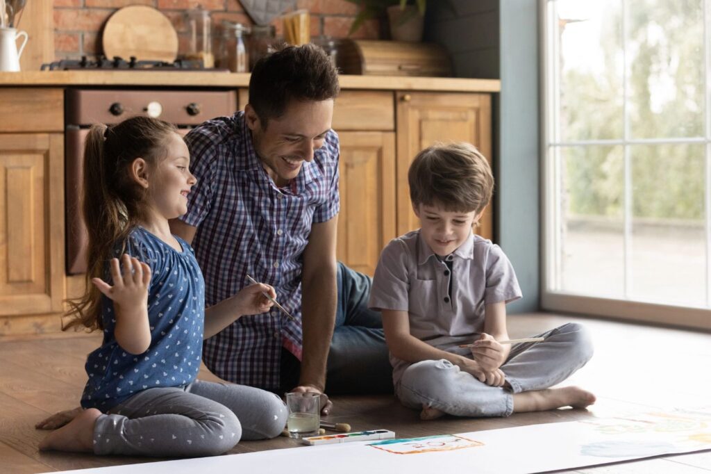 A father painting with his children.