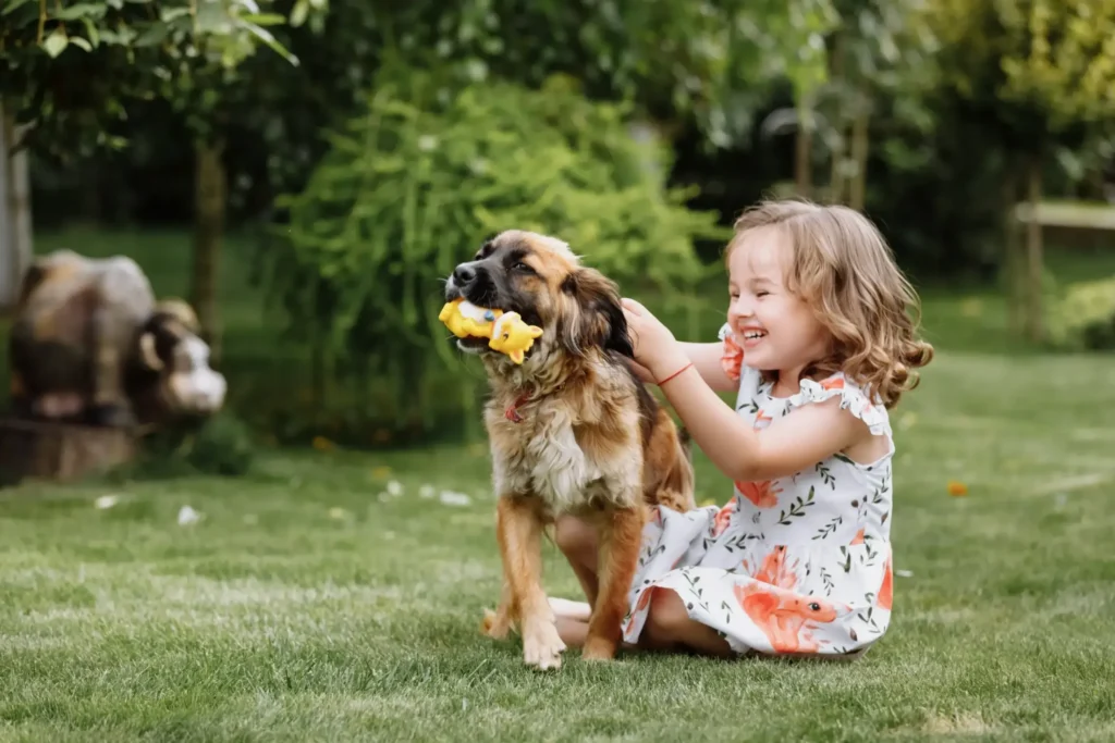 A joyful young child playing with a dog in the backyard, representing the personal rights and quality of life supported through Texas guardianship in Austin.
